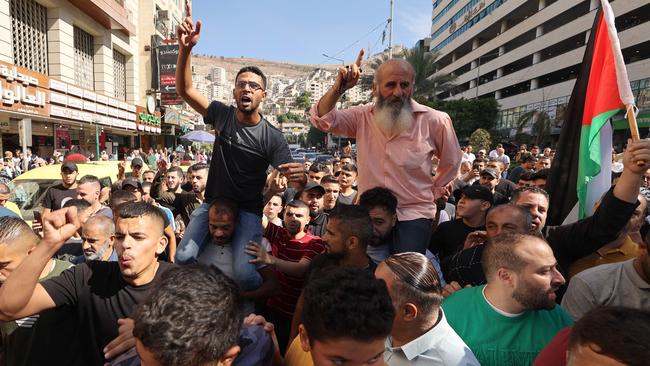 Palestinians in the West Bank city of Nablus celebrate on October 7, 2023, after fighters from the Gaza Strip infiltrated Israel, a major escalation in the Israeli-Palestinian conflict. (Photo by Jaafar ASHTIYEH / AFP)