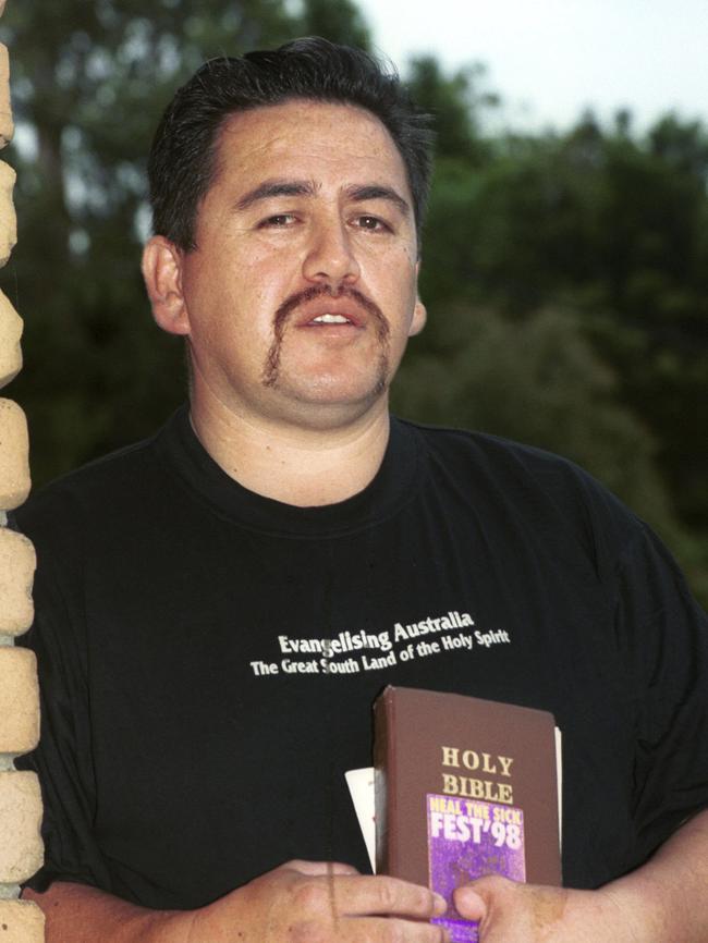 Reverend Terrence O'Brien holding his Holy Bible after being arrested. Pic Michael Ross.