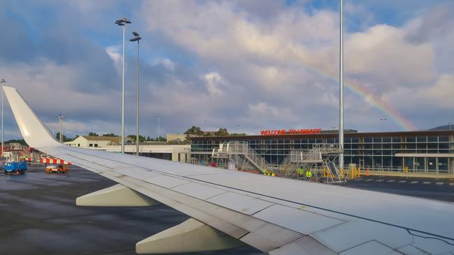 Airplane wing with rainbow. Hobart Airport.