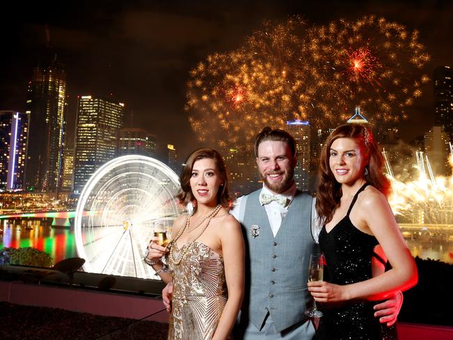 L to R, Vanessa Ingham from Auckland with Charles Walker from Braidwood, Hayley Ferris from Perth, they travel to a New Years in a different part of the world every year, this year New Years Eve is at Rydges Hotel South Brisbane. Picture: Steve Pohlner