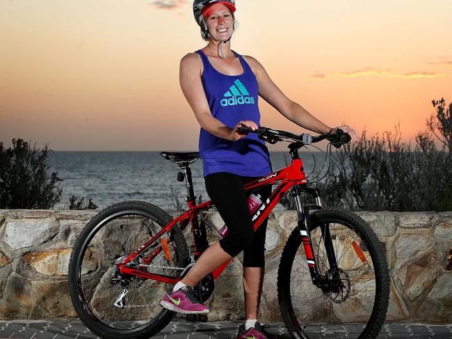 Christine Mason (042370296) rides her bike along Henley Beach esplanade. picture: Bianca De Marchi