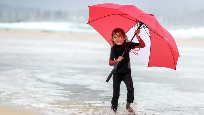 Coco Ward, 5 from Rainbow Bay, enjoys a day at the beach at Snapper Rocks during wet weather recently. Picture: Nigel Hallett