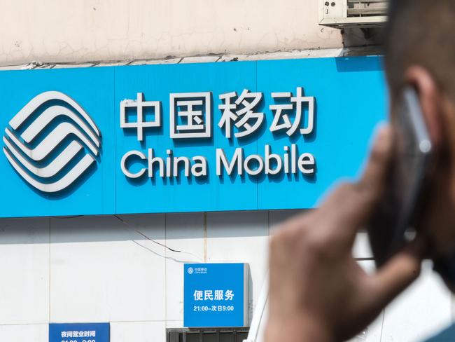 Signage for China Mobile Ltd. is displayed outside a store in Shanghai, China, on Tuesday, March 21, 2017. China Mobile is scheduled to release full-year earnings results on March 23. Photographer: Qilai Shen/Bloomberg