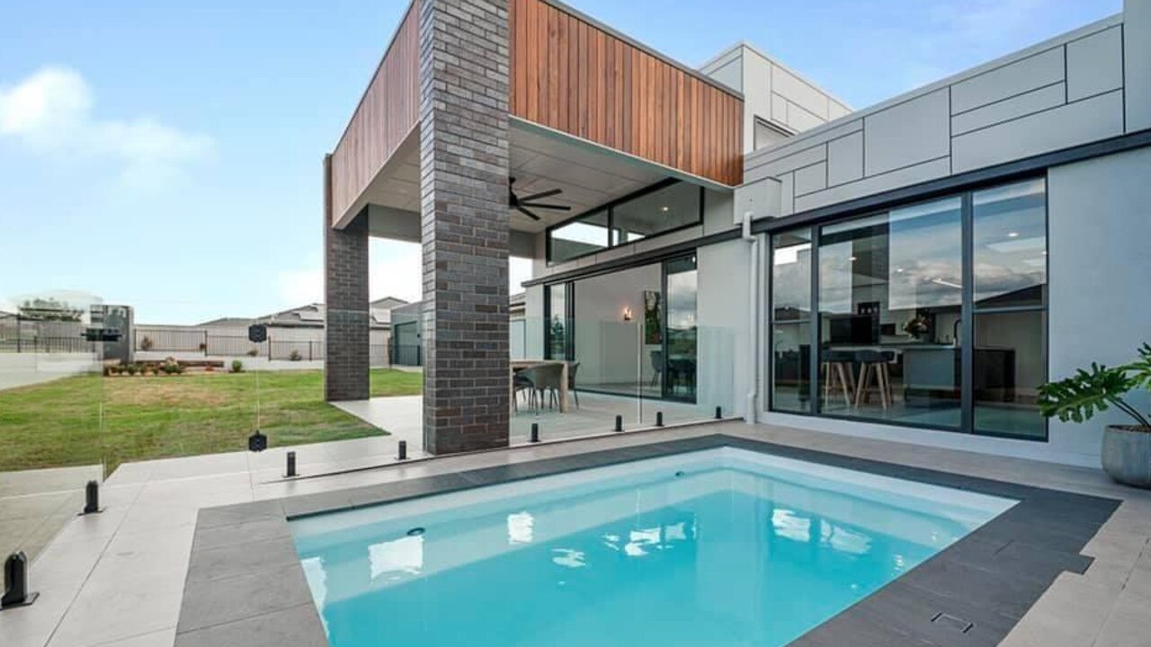 The backyard of the Hughes Elite Builders award-winning display home features a swimming pool and plenty of modern architectural features. Photo: Hughes Elite Builders