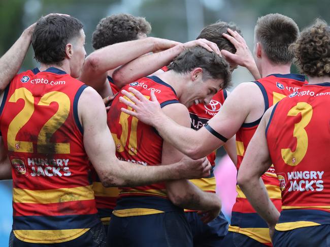 Billy Dowling from the Crows (centre) celebrates a goal with team mates during the Round 17 SANFL match between Sturt and Adelaide at Unley Oval in Adelaide, Saturday, August 19, 2023. (SANFL Image/David Mariuz)