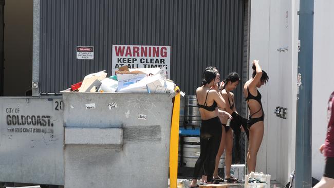 Surfers Paradise is to get a revamp. Here are shots of swimmers showering next to bins and kegs behind the Surfers SLSC in Hanlan Street. Picture: Glenn Hampson.