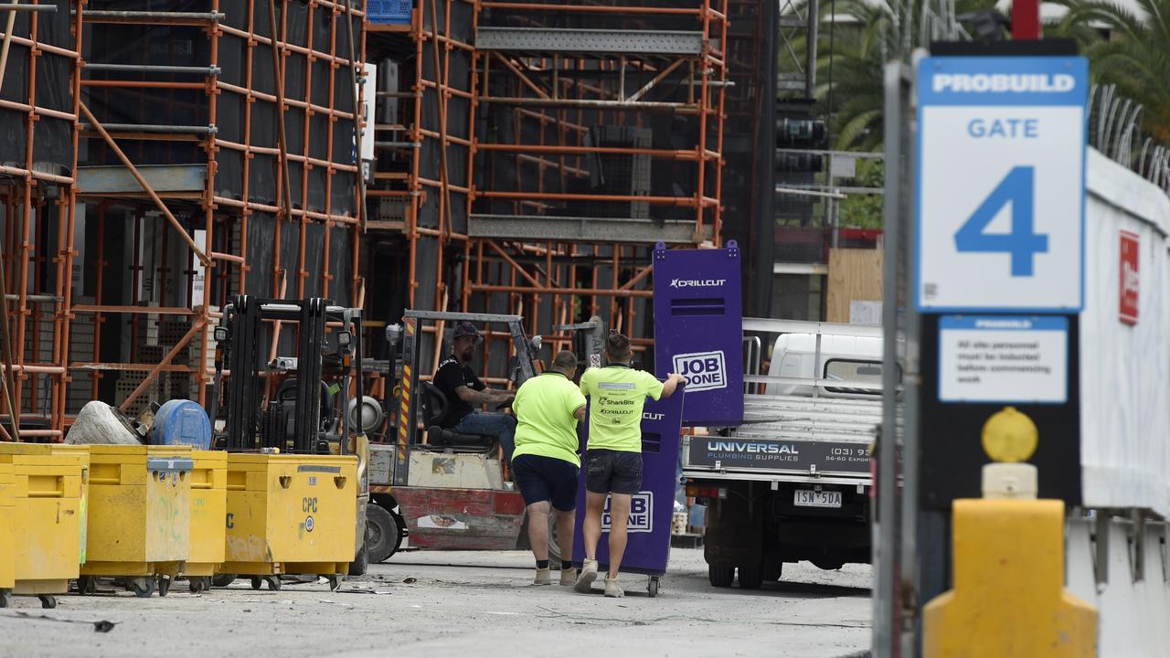 Workers remove equipment from a Probuild construction site next to Caulfield Racecourse in Melbourne. Picture: NCA NewsWire/Andrew Henshaw