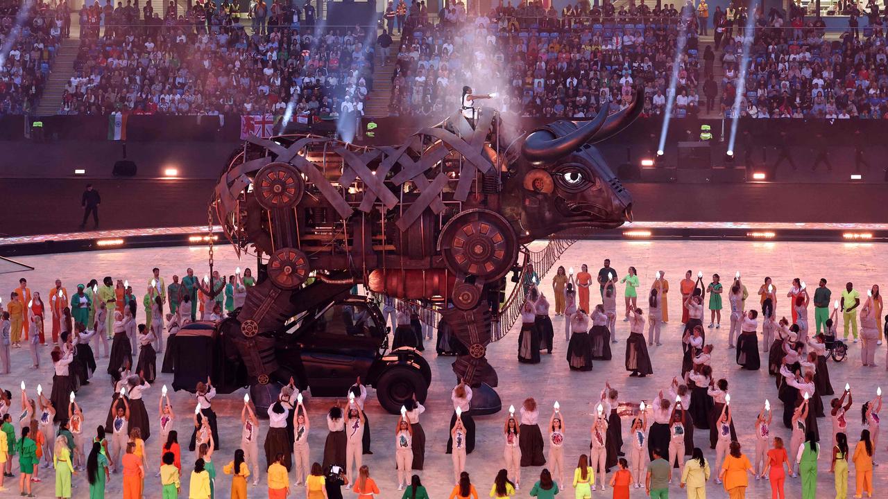 Performers remove the headpiece of the “Raging Bull” during the opening ceremony. (Photo by DARREN STAPLES / AFP)