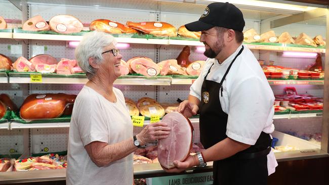 Butcher Steve Hancock sells a ham to customer Sue Noble at Stapleton Family Meats in Gymea. Picture: Brett Costello