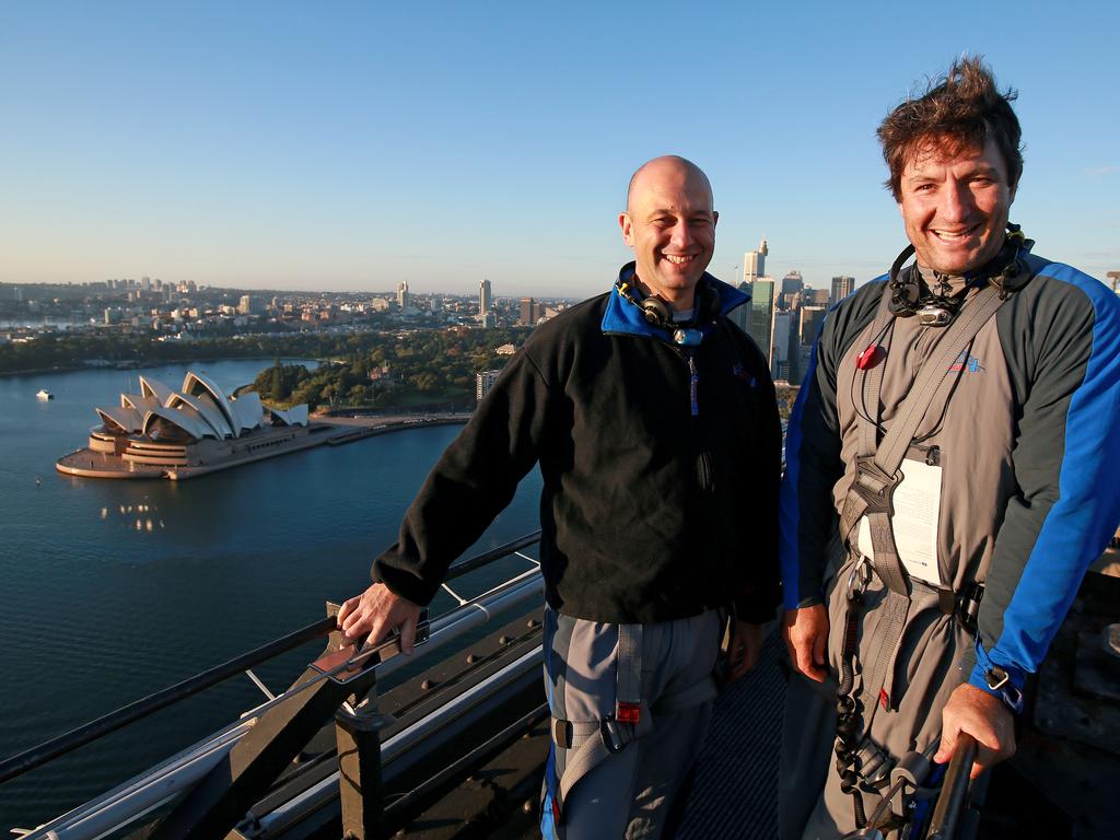 A dawn service was held on the summit of the Sydney Harbour Bridge to commemorate ANZAC Day. Money raised by the members of the public who climbed the bridge went to RSL DefenceCare. NRL CEO Todd Greenberg (L) and former Parramatta Eels player Nathan Hindmarsh were some of those in attendance. Picture: Toby Zerna