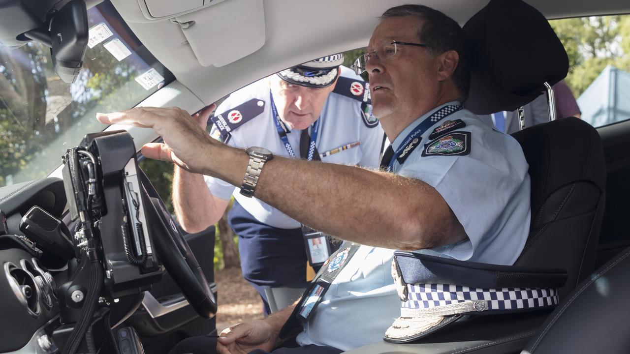 Queensland Police Commissioner Ian Stewart sits inside the new Kia Stinger highway patrol car as Assistant Commissioner (Road Policing Command) Mike Keating looks on. Picture: Supplied.