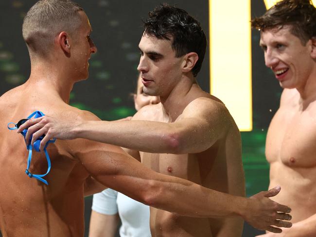 Thomas Neill (C) congratulated by his fellow swimmers after his second place. Picture: David Gray / AFP