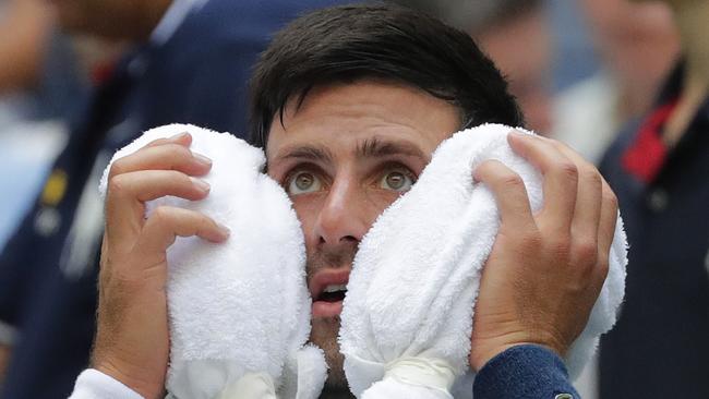 Not throwing in the towel … Novak Djokovic cools down with an ice towel. Photo: AP