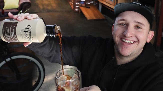 Head distiller Luke Ridden pours a shot of world beating Barbershop Coffee Liqueur at the Granddad Jack’s Miami distillery. Picture: Glenn Hampson