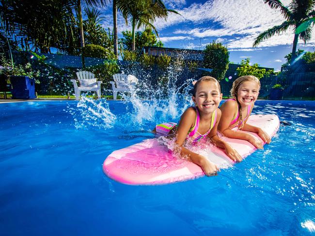 ** SUNDAY PAPERS ** Real Estate - Story about how much value pools add to homes in QLD suburbs. Krystal and Tim Kennedy (** WOULDNT BE IN PIC**) with their daughters Elke, 8 and Zara Kennedy, 10 in their Burleigh Waters family home pool which they are selling,Picture: Nigel Hallett** DOG name - Maple -