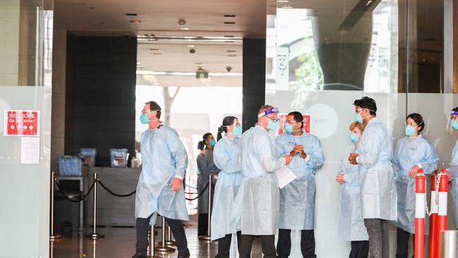 Hotel Quarantine workers wearing full PPE at the Grand Hyatt. Picture: Getty