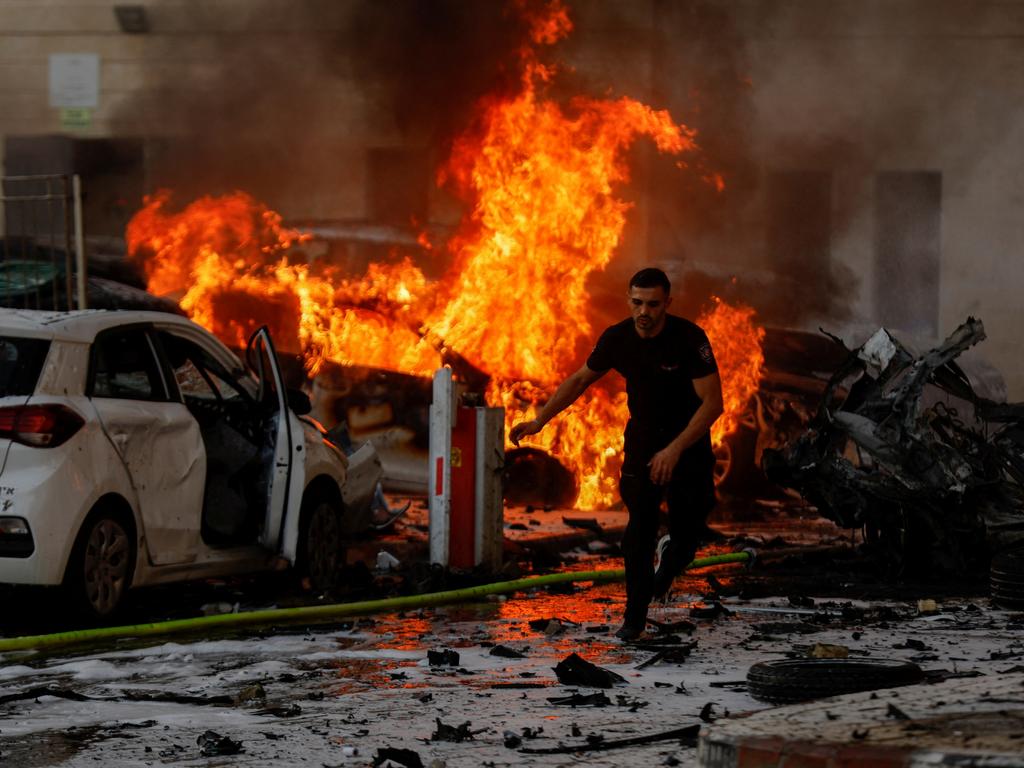 A man in Ashkelon, Israel, in the aftermath of a rocket strike launched from the Gaza Strip. Picture: Amir Cohen/Reuters