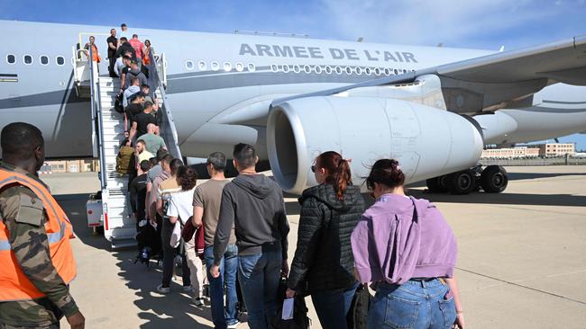 Staff from civil defense, officers from the Marseille Naval Fire battalion and French Gendarmerie officers board an Airbus A330. Picture: AFP