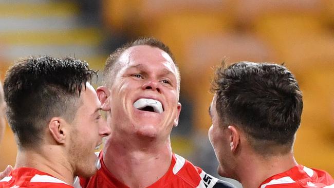 Lindsay Collins (centre) of the Roosters celebrates scoring a try with team mates Sam Verrills (left) and Kyle Flanagan (right) during the Round 4 NRL match the Brisbane Broncos and the Sydney Roosters at Suncorp Stadium in Brisbane, Thursday, June 4, 2020. (AAP Image/Darren England) NO ARCHIVING, EDITORIAL USE ONLY