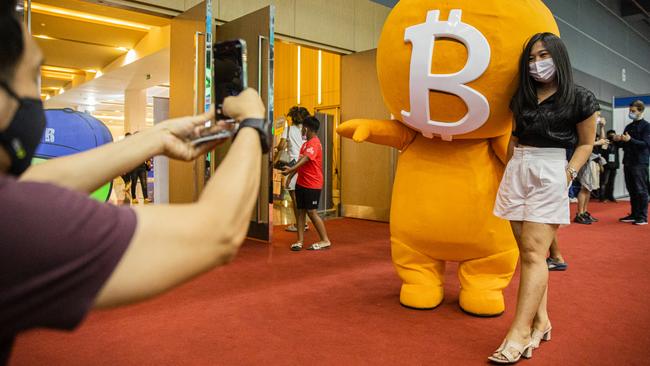 A woman poses with a Bitcoin mascot during the Thailand Crypto Expo on May 14. Picture: Lauren DeCicca/Getty Images