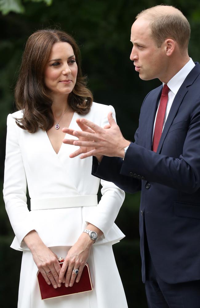 Note Kate’s red clutch bag ... and Wills’ red tie. Picture: Getty Images