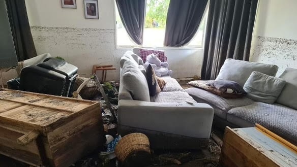 Natalie Watt and her two daughter, Lydia (six months) and Indiana (20 months) are living in a caravan while their Eugowra home needs to be completely repaired following the floods.