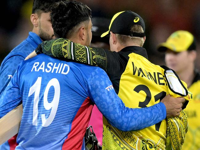 Afghanistan's Rashid Khan with David Warner at the T20 World Cup in Australia in 2022. Picture: Brenton EDWARDS / AFP