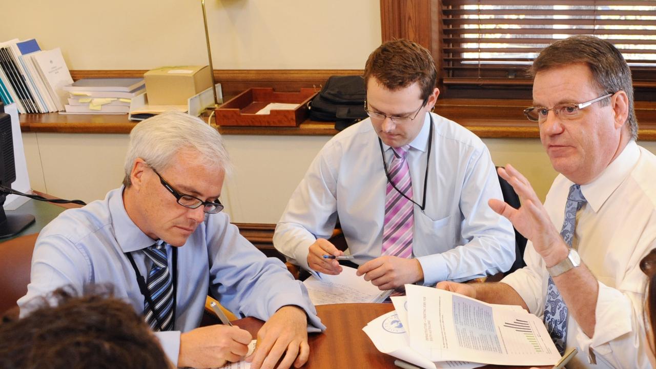 The-then Labor Treasurer Kevin Foley makes the finishing touches to the 2009/10 State Budget. (L-r) Rik Morris, Stephen Mullighan and Kevin Foley.