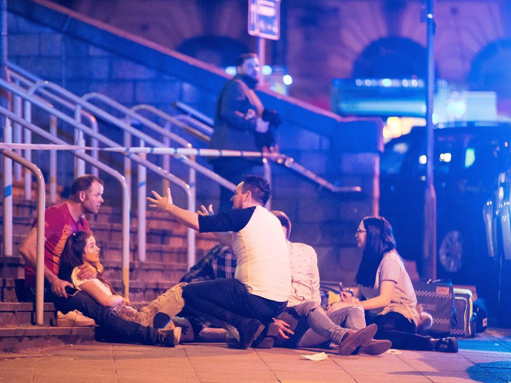 Injured people are seen near the Manchester Arena after reports of an explosion during an Ariana Grande concert. Picture: Joel Goodman/LNP