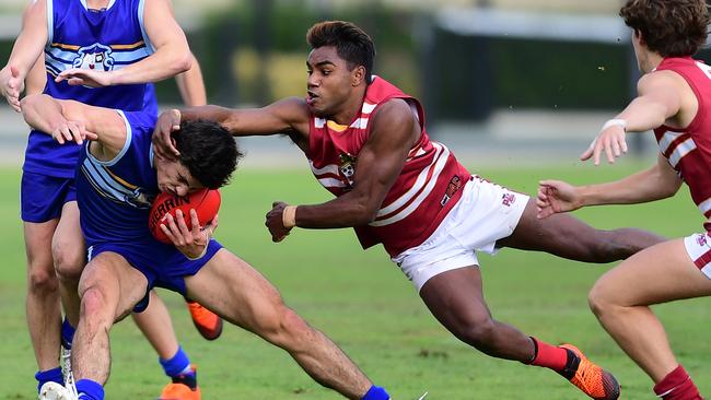 Prince Alfred’s Kysaiah Pickett tackles Sacred Heart’s Max Harry during the Messenger Shield clash on Saturday. Picture: AAP/Mark Brake