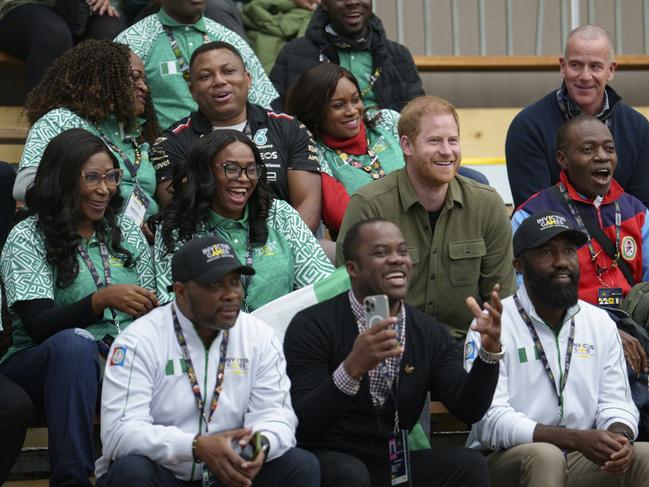 Prince Harry sits with Team Nigeria as they watch the Sitting Volleyball event at the Invictus Games in Vancouver. Picture: Getty Images