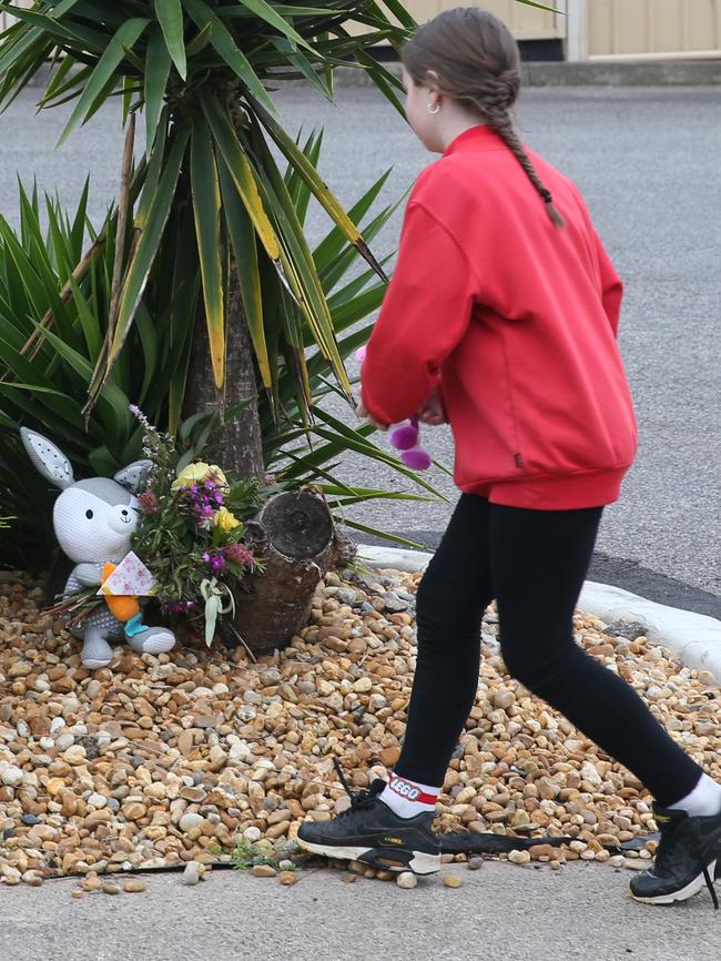 Amber, 10, places a toy at the scene. Picture: David Crosling