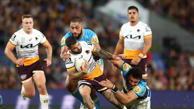 GOLD COAST, AUSTRALIA - APRIL 15: Adam Reynolds of the Broncos is tackled during the round seven NRL match between Gold Coast Titans and Brisbane Broncos at Cbus Super Stadium on April 15, 2023 in Gold Coast, Australia. (Photo by Chris Hyde/Getty Images)