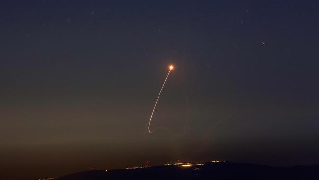 Rockets fired from southern Lebanon are intercepted by Israel's Iron Dome air defence system over the Upper Galilee region in northern Israel on September 27. Picture: Jalaa Marey / AFP