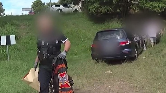 Police remove items after a raid following an assault at a Scenic Rim cafe.