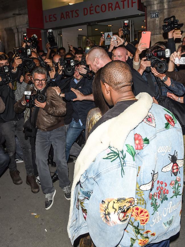 Bodyguard Pascal Duvier clears the crowd as Kim Kardashian and Kanye West arrive at the Balmain after party in Paris. Picture: Splash
