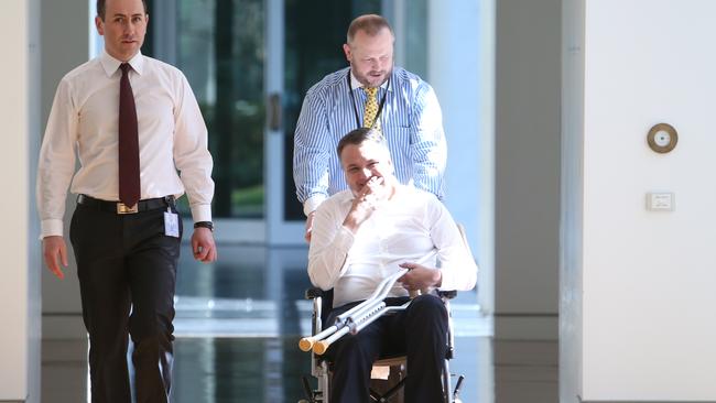 Jamie Briggs is wheeled to a party room meeting at Parliament House.