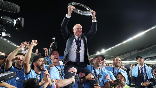 Sydney coach Graham Arnold lifts the trophy with Sydney FC after the grand final win. Picture: Brett Costello