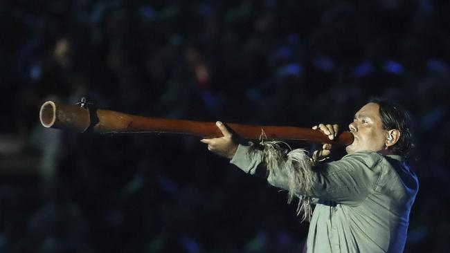 A man plays the didgeridoo, a traditional Aboriginal instrument, during the opening ceremony for the 2018 Commonwealth Games at Carrara Stadium on the Gold Coast, Australia, Wednesday, April 4, 2018. Photo: Dita Alangkara