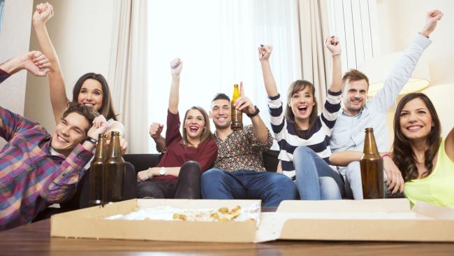 Group of friends watching TV match and cheering. Picture: iStock