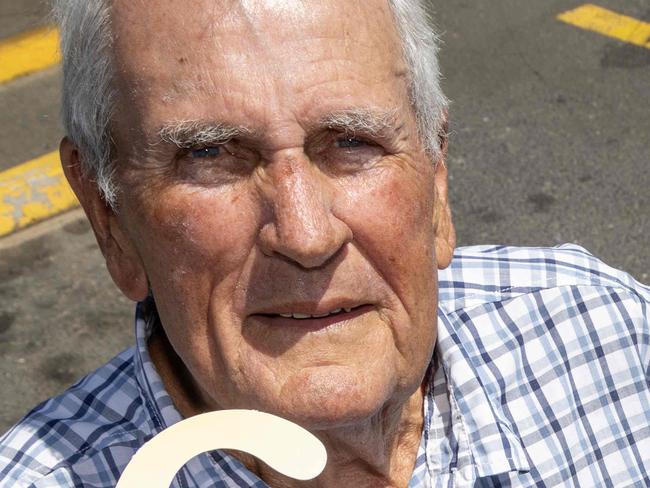 February 11, 2025:  John Houlahan accidentally parked in a disabled spot without his disability parking permit. He later showed council the permit, but they're insisting the 80+ year old jumps through hoops and red tape to waive the fee. Picture of John holding his disabled permit, outside a disabled parking spot. Picture: Kelly Barnes