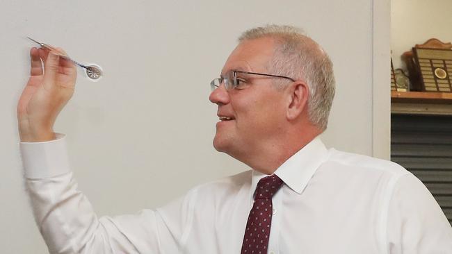 Prime Minister Scott Morrison plays a round of darts at the Cairns and District Darts Association Hall. Picture: Brendan Radke