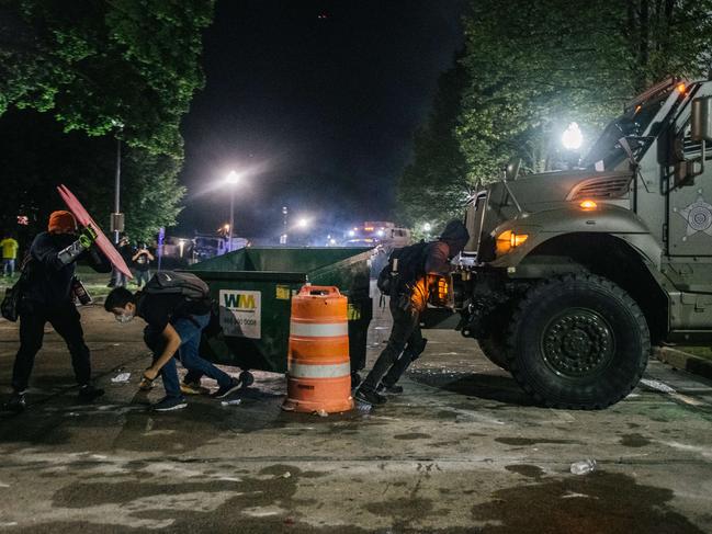 Demonstrators attempt to block an armoured police vehicle on August 25, 2020 in Kenosha, Wisconsin. Picture: Getty Images/AFP