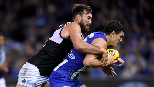 Charlie Dixon wraps up North Melbourne’s Scott Thompson. Picture: AAP Image/Joe Castro