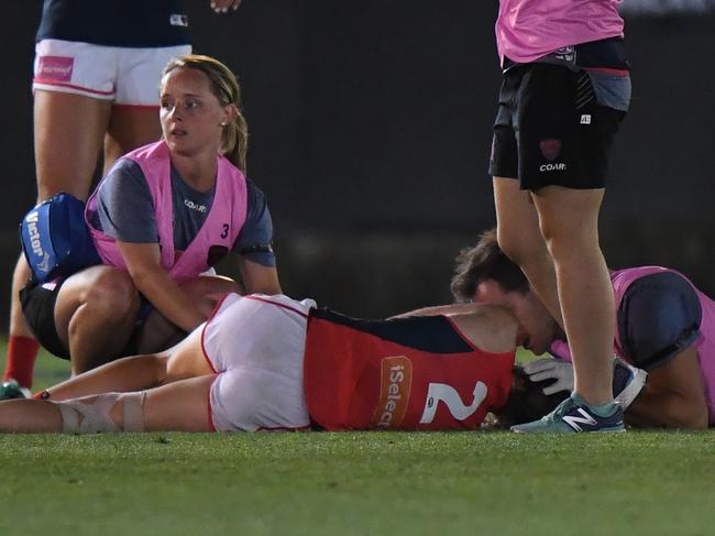 Meg Downie of Melbourne on the ground after being knocked out during their WAFL match at the Ikon Stadium in Melbourne on Saturday, February 11, 2017. (AAP Image/Mal Fairclough) NO ARCHIVING, EDITORIAL USE ONLY