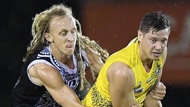 Jonathan Peris of Nightcliff Tigers goes for the ball against Palmerston Magpies. Picture: Felicity Elliott / AFLNT Media