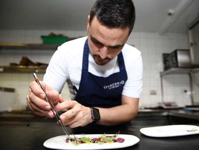 Victor Moya pictured plating up the salad of parmesan.