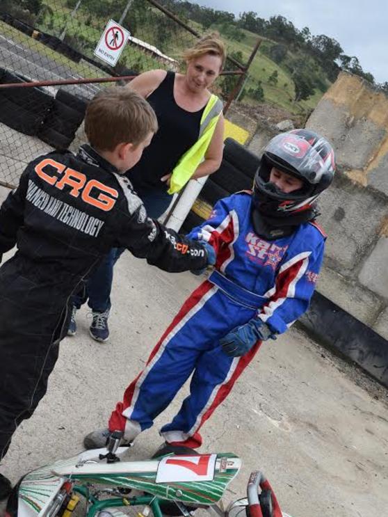 Lachlan Campbell (right) shakes hands following a go-kart race earlier this year.