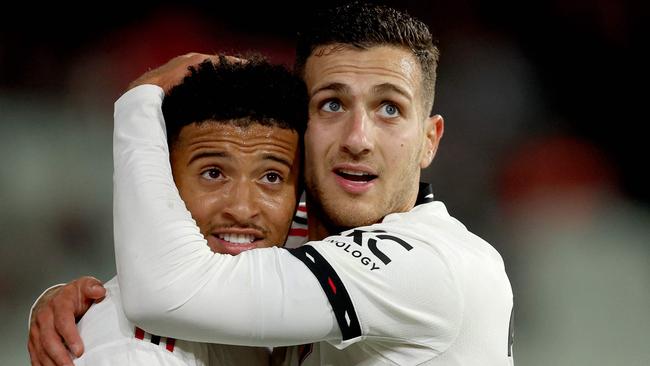 United’s Jadon Sancho Diogo Dalot celebrate a goal on the MCG. Picture: AFP