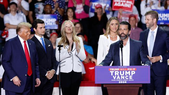 Donald Trump Jr. speaks as Donald Trump (L) listens alongside Tiffany Trump's spouse Michael Boulos (2nd L), Tiffany Trump (3rd L), Co-chair of the Republican National Committee Lara Trump (3rdR) and Eric Trump (R), during a campaign rally at Van Andel Arena in Grand Rapids, Michigan. Picture: AFP